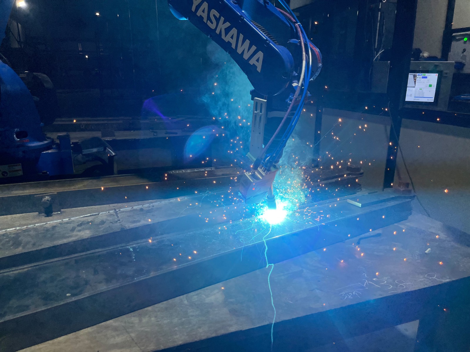 Yaskawa industrial robot welding a steel assembly in a Kiaan Robotics cell